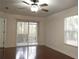 Bright living room featuring hardwood floors and sliding glass doors at 8846 Coral Palms Ct # A, Kissimmee, FL 34747