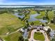 Panoramic aerial view of the community featuring a golf course, clubhouse, lakes, and residential area at 13809 Abberwick Dr, Orlando, FL 32832