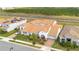 Aerial view of home showcasing a red-tiled roof, lush landscaping, and a convenient two-car garage at 13809 Abberwick Dr, Orlando, FL 32832