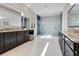 A bathroom features dual sinks, granite countertops, a walk-in shower with blue accents, and natural light at 13809 Abberwick Dr, Orlando, FL 32832