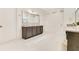 Spacious bathroom with double granite-top vanity and a large mirror at 13809 Abberwick Dr, Orlando, FL 32832