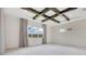 A spacious primary bedroom showcases a unique coffered ceiling and large windows with natural light at 13809 Abberwick Dr, Orlando, FL 32832