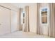Bedroom featuring two windows with curtains and large sliding door closet at 13809 Abberwick Dr, Orlando, FL 32832