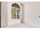 Bright bedroom featuring a large arched window and neutral decor at 13809 Abberwick Dr, Orlando, FL 32832