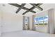 Primary bedroom featuring a coffered ceiling, light-colored carpet, and large windows at 13809 Abberwick Dr, Orlando, FL 32832