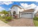 Beautiful home boasts a brick-paved driveway, lush landscaping, stone accents, and a two-car garage at 13809 Abberwick Dr, Orlando, FL 32832