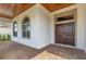 Elegant front entryway featuring a brick-paved patio, arched windows, and a solid wood double-door at 13809 Abberwick Dr, Orlando, FL 32832