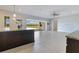 Modern kitchen island with granite countertops, open layout, and access to the outdoor living area at 13809 Abberwick Dr, Orlando, FL 32832