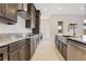 A kitchen features granite countertops and stainless steel appliances and ample dark wood cabinets at 13809 Abberwick Dr, Orlando, FL 32832