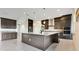 Kitchen featuring sleek cabinets, stainless steel appliances, and a large central island with a stone counter at 13809 Abberwick Dr, Orlando, FL 32832