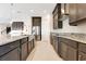 Kitchen with a large island, a stainless steel refrigerator, and dark cabinets providing ample storage at 13809 Abberwick Dr, Orlando, FL 32832