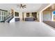 Open-concept living space featuring a staircase, kitchen, and seamless indoor-outdoor living at 13809 Abberwick Dr, Orlando, FL 32832