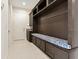 Custom mudroom with built-in bench, storage cabinets and granite countertop at 13809 Abberwick Dr, Orlando, FL 32832