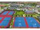 Aerial view of community sports courts featuring tennis and basketball, near a pool and playground at 13809 Abberwick Dr, Orlando, FL 32832