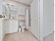 An en-suite bathroom features tile floors, a shower-tub combo, and ample cabinet space at 8910 Legacy Ct # 206, Kissimmee, FL 34747
