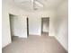 The bedroom is bright and open, featuring carpeted floors, a ceiling fan, and two closets at 8910 Legacy Ct # 206, Kissimmee, FL 34747