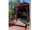 Charming wooden gazebo with seating, nestled in a serene, wooded area perfect for relaxation at 8910 Legacy Ct # 206, Kissimmee, FL 34747
