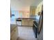A kitchen shot with an open design includes an eat-in bar, modern appliances, and tile floors at 8910 Legacy Ct # 206, Kissimmee, FL 34747