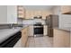 A view of the kitchen features neutral cabinets and stainless steel appliances at 8910 Legacy Ct # 206, Kissimmee, FL 34747