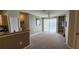 View of the living room with a ceiling fan, built-in shelves, and sliding glass doors that allow plenty of natural light at 8910 Legacy Ct # 206, Kissimmee, FL 34747