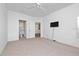 A comfortable main bedroom includes an en-suite bathroom and a mounted television at 8910 Legacy Ct # 206, Kissimmee, FL 34747