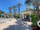 Community poolside area with ample seating, tropical landscaping, and umbrellas for comfortable relaxation at 8910 Legacy Ct # 206, Kissimmee, FL 34747