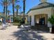 Community poolside area with ample seating, tropical landscaping, and umbrellas for comfortable relaxation at 8910 Legacy Ct # 206, Kissimmee, FL 34747