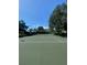 Well-maintained community tennis court surrounded by lush landscaping and greenery on a bright, sunny day at 8910 Legacy Ct # 206, Kissimmee, FL 34747