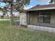 View of the backyard showing the screened-in porch and a partial lake view at 98 Pine Island Cir, Kissimmee, FL 34743