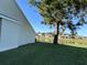 Backyard features a well-maintained lawn and beautiful view of the pond at 98 Pine Island Cir, Kissimmee, FL 34743