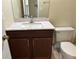 Bathroom vanity featuring dark wood cabinets, sink, mirror, and stylish fixtures at 98 Pine Island Cir, Kissimmee, FL 34743