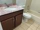 Bathroom with vanity, sink, cabinet and neutral tilework at 98 Pine Island Cir, Kissimmee, FL 34743