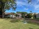 Charming single-story home featuring a well-manicured lawn and a cozy front porch at 98 Pine Island Cir, Kissimmee, FL 34743