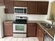 Kitchen featuring stainless steel appliances, granite countertops, and tile backsplash at 98 Pine Island Cir, Kissimmee, FL 34743