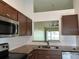Bright kitchen features stainless steel appliances, tiled backsplash and granite countertops at 98 Pine Island Cir, Kissimmee, FL 34743