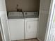 Laundry closet featuring a full-size washer and dryer at 98 Pine Island Cir, Kissimmee, FL 34743