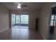 Bright living room with tile flooring and sliding glass doors leading to a screened lanai at 98 Pine Island Cir, Kissimmee, FL 34743