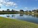 Scenic view of a tranquil pond with lush green surroundings, perfect for relaxation at 98 Pine Island Cir, Kissimmee, FL 34743