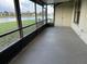 View of the screened-in porch showing lake views and a storage closet at 98 Pine Island Cir, Kissimmee, FL 34743