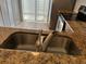 Close-up of the kitchen sink with granite countertop and stainless steel faucet at 98 Pine Island Cir, Kissimmee, FL 34743