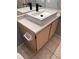 Modern bathroom sink vanity with black faucets and light wood cabinets at 13838 Fairway Island Dr # 1432, Orlando, FL 32837