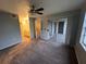 Spacious bedroom with carpet, ceiling fan, and access to a balcony at 13838 Fairway Island Dr # 1432, Orlando, FL 32837