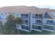 Three-story building with balconies and tile roofs in a tropical setting at 13838 Fairway Island Dr # 1432, Orlando, FL 32837