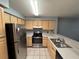 Efficient kitchen with stainless steel appliances and light wood cabinets at 13838 Fairway Island Dr # 1432, Orlando, FL 32837