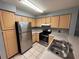 Efficient kitchen with stainless steel appliances and light wood cabinets at 13838 Fairway Island Dr # 1432, Orlando, FL 32837