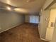 Spacious living room with carpeted floor and sliding glass doors at 13838 Fairway Island Dr # 1432, Orlando, FL 32837