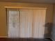 Sliding glass door with white vertical blinds leading to a balcony at 13838 Fairway Island Dr # 1432, Orlando, FL 32837