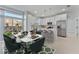 Bright kitchen and dining area with white cabinets, stainless steel appliances, and an eat-in island at 1603 Tench Ct, Kissimmee, FL 34759