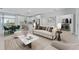 Open-concept living room and kitchen with modern finishes and stainless steel appliances at 1603 Tench Ct, Kissimmee, FL 34759