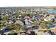 Wide aerial shot featuring homes in a scenic community with a lake in the background at 1756 Derby Glen Dr, Orlando, FL 32837